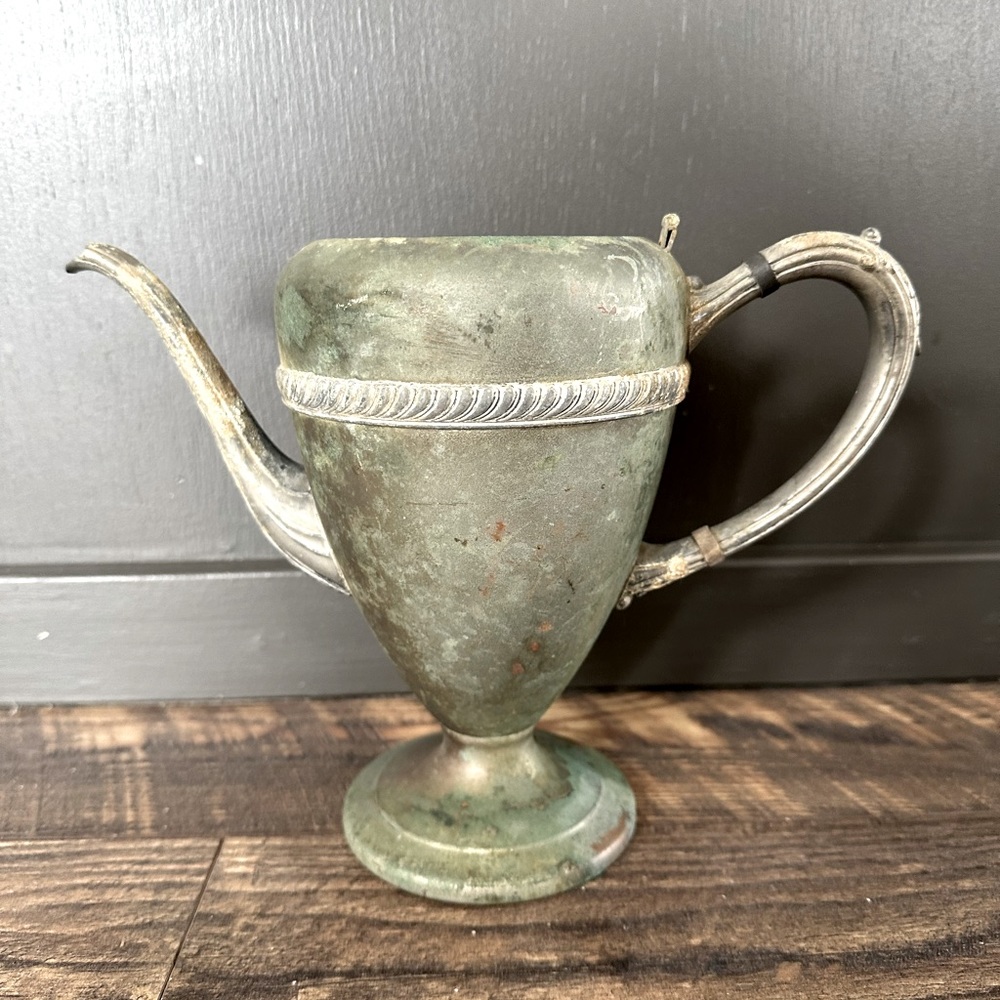 Vintage silver plate over copper coffee pot.